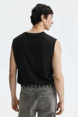 Musculosa de punto liviano con cuello redondo y sisas con ribete acanalado. Presenta un corte estándar y bajo recto, diseñada con tecnología de fibra sintética para transporte de humedad.