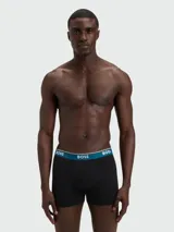 Pack de tres bóxers ajustados de algodón, color negro, con cintura elástica en contraste color azul petróleo y logo de la marca estampado en blanco.