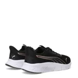 Championes deportivos Puma modelo Flex Focus Lite Modern, color negro con detalles en tono cobre metalizado. Presentan capellada de malla transpirable, cierre con cordones y suela blanca de goma con diseño flexible.
