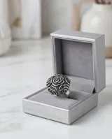 Anillo de plata 925 con diseño de flores en bajo relieve y acabado empavonado.