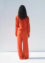 Pantalon de tiro medio con diseño recto y largo, confeccionado en tejido con efecto crinkle o arrugado. Cuenta con cintura elástica con cordón ajustable y forro interior.