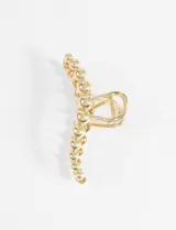 Broche dorado para el pelo con forma de pinza y detalle de esferas en relieve.