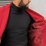 Tapado de lana color negro, con cuello solapa y cierre de dos botones. Corte recto y largo hasta la rodilla.