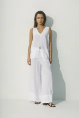 Blusa blanca sin mangas con escote en V y abertura frontal.