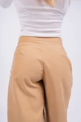 Pantalón gris de vestir, de corte palazzo y tiro alto.