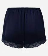 Short de pijama azul marino de satén con acabado brillante y caída fluida, cintura elastizada con moño decorativo y detalles de encaje en los bajos.