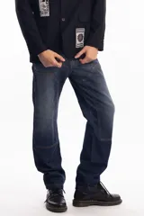 Pantalón de jean azul oscuro de corte recto, con refuerzos en las rodillas y bolsillos laterales. Diseño de estilo cargo con frente reforzado.