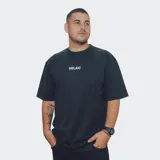 Remera de algodón color negro con efecto lavado, corte oversize y texto blanco 'RELAJO' centrado en el pecho.