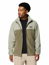 Campera polar Columbia modelo Steens Mountain con cierre frontal completo, cuello alto y bolsillos laterales con cierre. Presenta un diseño de bloques de color en tonos verde claro y verde oliva, con el logo de la marca bordado en el pecho.