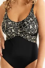 Malla entera negra con estampado abstracto en blanco y negro en la parte superior, escote cruzado y breteles finos regulables.
