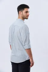 Camisa de lino a rayas verticales blancas y azules, de manga larga, con cuello mao y cierre frontal de botones.