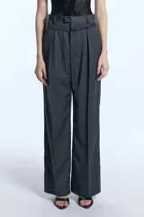 Pantalón sastrero de tiro alto con diseño rayado y fit amplio. Presenta una doble cintura con detalle descosido, pinzas delanteras y traseras, y bolsillos ojal en la parte posterior.