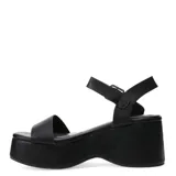 Sandalias de plataforma alta con pulsera al tobillo Miss Carol Krova, color negro, con tira frontal ancha y hebilla metálica plateada.
