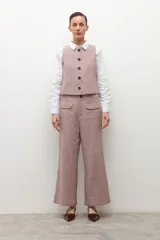 Pantalón tipo culotte de tiro alto con estampado de cuadros pequeños en tonos beige y marrón. Presenta bolsillos frontales tipo parche y corte recto de pierna ancha.