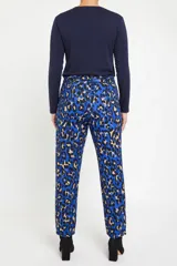 Pantalón de corte recto con estampado animal print en tonos azules, negros y beige. Presenta cintura elástica con lazo ajustable del mismo tejido y bolsillos laterales.