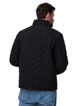 Chaqueta acolchada negra con diseño de costuras en zigzag, cierre frontal de cremallera y cuello alto. Presenta el logo de la marca bordado en amarillo en el pecho.