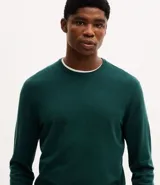 Suéter de punto para hombre, con cuello redondo, mangas largas y puños y bajo acanalados.