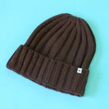 Gorro tipo beanie tejido en punto canalé, con doblez en el borde y etiqueta pequeña con logo N+.