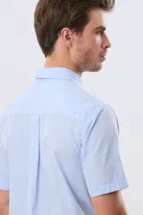 Camisa sport celeste de manga corta con cuello abotonado y bolsillo frontal en el pecho.