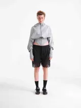 Campera corset de tela deportiva fina en color gris, con diseño de manga larga con abertura para el pulgar y cintura elastizada de corte estructurado.