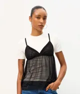Remera baby tee de algodón con superposición de musculosa transparente de tul negro con breteles finos y escote en V.