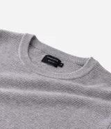 Suéter de punto para hombre, color celeste, con textura acanalada horizontal, cuello redondo y mangas largas con puños ajustados.