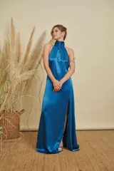 Vestido largo de satén color azul, con cuello halter alto y tajo lateral profundo en la falda.