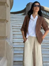 Blazer blanco de lino con solapas y bolsillos frontales.