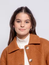 Tapado corto de paño con cuello camisero, cierre frontal de botones veteados y dos bolsillos frontales tipo parche. Presenta un diseño de corte recto y mangas largas.