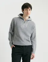 Remera de punto inglés con cuello alto y medio cierre metálico. Presenta mangas largas y puños en punto canalé.
