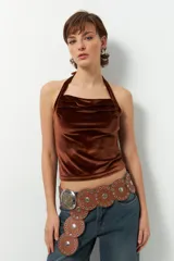 Top marrón de terciopelo, sin mangas, con cuello halter y espalda descubierta.