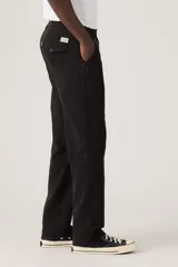 Pantalón chino de corte relajado, confeccionado en sarga de algodón resistente, con diseño de cinco bolsillos y cierre de cremallera con botón.