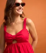 Blusa fucsia de tricolina de algodón con escote corazón, recorte cutout en el busto, volado en el bajo y cierre por cremallera en la espalda.