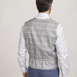 Chaleco reversible Due Volti de corte sastrero, con diseño a cuadros en tonos de gris y cierre frontal con cuatro botones oscuros.