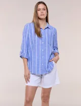 Camisa de lino de la marca Dash, color beige con rayas verticales blancas. Cuenta con cuello camisero, cierre frontal con botones, un bolsillo aplicado en el pecho y mangas largas con sistema de ajuste para arremangar.
