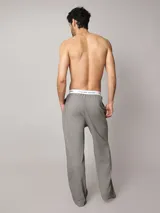 Pantalón de pijama Calvin Klein de corte regular y pierna recta, color gris, confeccionado en punto de algodón suave. Cuenta con bolsillos en las costuras laterales y cinturilla elástica distintiva de la marca.