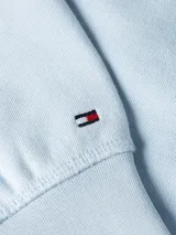 Buzo celeste de algodón con capucha y cordón ajustable. Logo de Tommy Hilfiger bordado en el pecho.