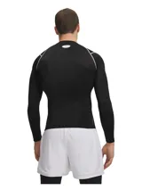 Remera térmica deportiva Under Armour HeatGear Elite Compression de manga larga, color negro con costuras planas en contraste gris claro. Cuenta con ajuste de compresión, cuello redondo y el logo de la marca estampado en el pecho.