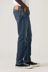 Pantalón de jean corte regular taper, con diseño de cinco bolsillos, cierre de botón y cremallera, y acabado en tono azul medio con efecto desgastado.