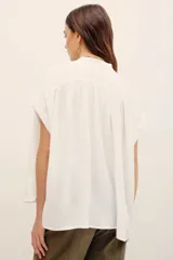 Camisa blanca de viscosa con cuello en V y mangas cortas de diseño holgado.