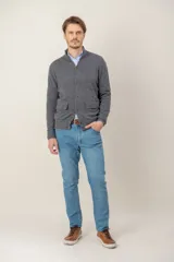 Sweater de lana lambswool color gris, con cuello alto, cierre frontal de botones y dos bolsillos delanteros tipo parche.