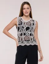 Blusa musculosa de crochet en color crudo con diseño calado de patrones florales y geométricos, escote redondo y terminación festoneada en el ruedo.