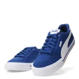 Championes urbanos Puma modelo Court Classic Vulc, de corte bajo, confeccionados en material textil color negro con la icónica franja lateral de la marca en blanco. Presentan una suela vulcanizada blanca con detalles en negro y una línea color caramelo en la base.