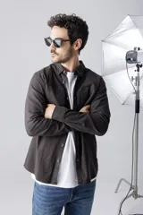 Camisa tipo sobrecamisa color verde militar, de manga larga, con cuello clásico, cierre frontal con botones y dos bolsillos de parche en el pecho.