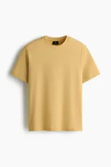 Remera H&M de algodón liviano en color mostaza, de corte estándar, manga corta y cuello redondo.