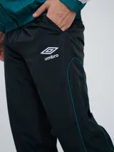 Pantalón de jogging Umbro color azul marino, de corte recto, con cintura elástica y líneas blancas decorativas a los laterales. Presenta el logo de la marca bordado en blanco en la pierna izquierda.