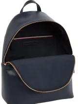 Mochila Tommy Hilfiger de diseño compacto en color azul marino. Presenta una franja vertical tricolor característica de la marca, logo TH metalizado en la parte frontal, asa superior y cierre principal con cremallera.