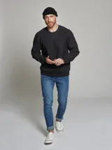 Sweater tejido color beige, de tejido grueso con textura, cuello a la base y manga larga.