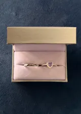 Set de dos anillos de plata 925. Incluye un anillo con piedra central en forma de corazón color violeta rodeada de zirconias y una alianza clásica tipo bombé de 3mm.
