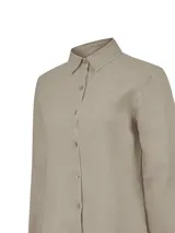 Blusa de manga larga color beige, de cuello camisero clásico y cierre frontal de botones.